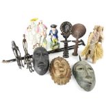 A collectors' lot to include three African carved wooden masks, two African tribal metal figures,