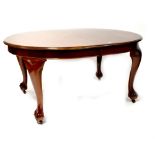 A Victorian-style D-end extending dining table with two extra leaves and wind-out mechanism,