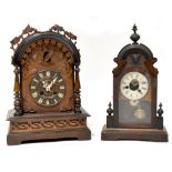 A Black Forest cuckoo clock, the arched cased with carved ivy leaf detail,