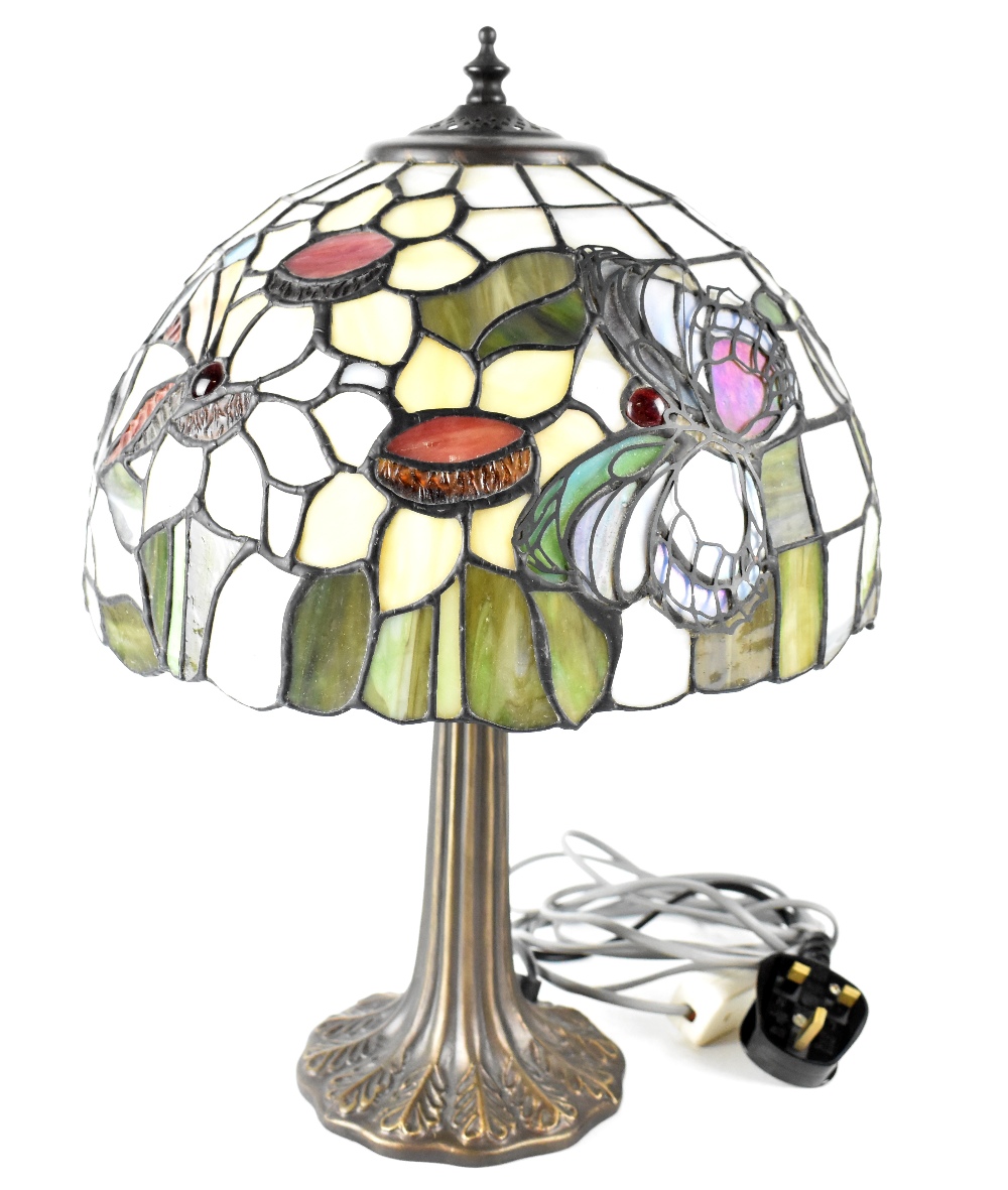 A Tiffany-style table lamp with floral and butterfly decoration to the shade, height 44cm.