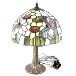 A Tiffany-style table lamp with floral and butterfly decoration to the shade, height 44cm.