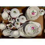 Two matching Meissen tea sets, both hand painted with pink roses, comprising two teapots,
