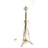An Arts and Crafts brass standard lamp with applied copper decoration,