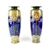 A pair of Royal Doulton Secessionist tall cylindrical sunflower vases, monogrammed to base MB, no.