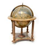 A reproduction globe drinks cabinet with fitted interior, on wrythen turned columns and undertier,