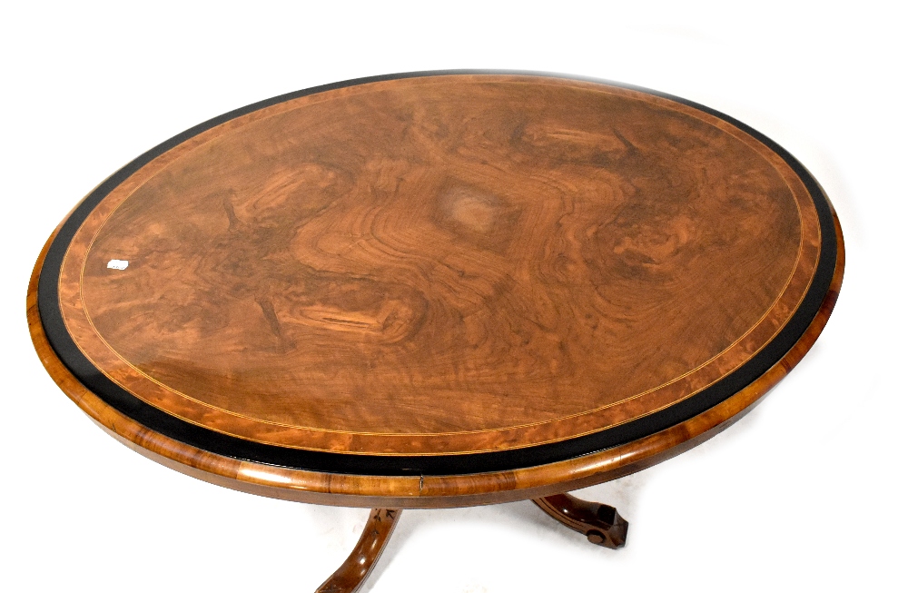 A Victorian walnut oval tilt-top dining table with inlay, - Image 2 of 2