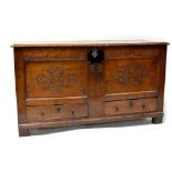 A Georgian carved oak mule chest with iron escutcheon,