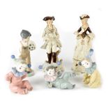 A group of four Nao figures, three babies dressed as jesters,