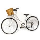 A Claude Butler Cambridge Heritage bicycle in white with wicker basket.