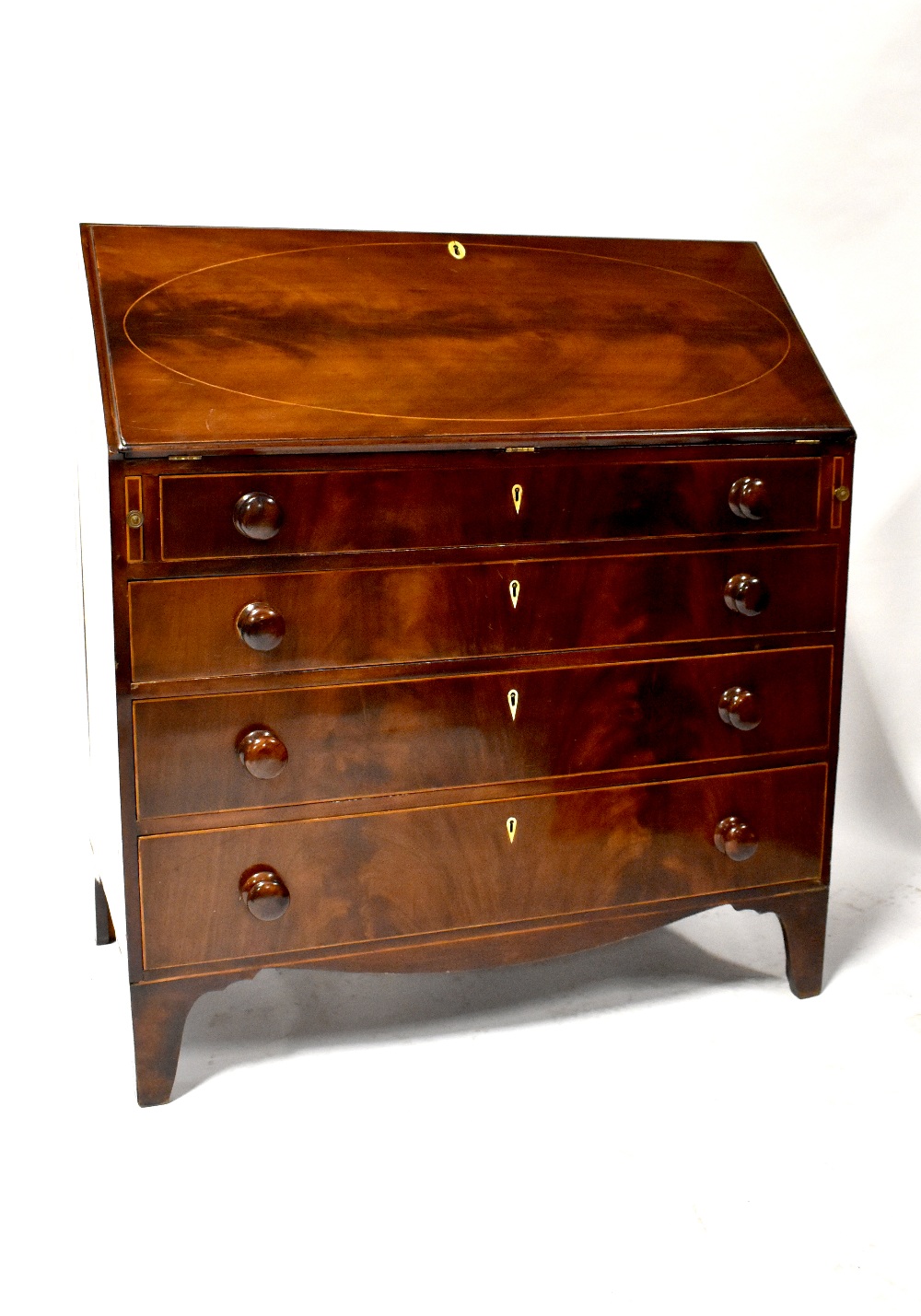 A 19th century mahogany bureau with inlaid fall front above four graduated drawers,