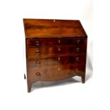 A 19th century mahogany bureau with inlaid fall front above four graduated drawers,