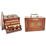 A late 19th/early 20th century Oriental hardwood and brass-bound Mahjong set with polished bone