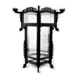 A Chinese ebonised wooden handing ceiling lantern with six etched glass panels depicting bamboo and