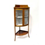 An Edwardian inlaid mahogany bow-fronted display cabinet with pair of glazed cupboard doors and