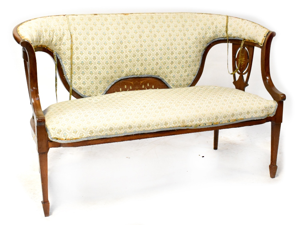 An Edwardian inlaid mahogany bowed two-seater settee with upholstered back and pierced vase splats,