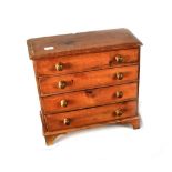 An early 20th century pine four-drawer apprentice chest on bracket supports, 30 x 32cm.