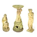 A reconstituted stone birdbath, the column in the form of a putto on a naturalistic base,