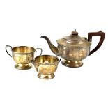 A George V hallmarked silver three-piece tea service comprising teapot, sugar bowl and milk jug,
