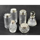 A group of six perfume and trinket pots with hallmarked silver tops and collar,