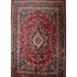 A Persian (Iranian), Mashad, red ground handmade woollen carpet, 385 x 310cm.