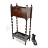 An early 20th century oak umbrella stand raised on barleytwist supports, height 64cm, width 30.