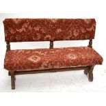 A late 19th century oak Gothic Revival bench with floral upholstery to Pugin style shaped supports