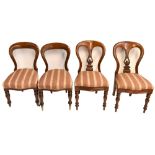 A set of six Victorian mahogany balloon back dining chairs, terminating on brass castors, and two