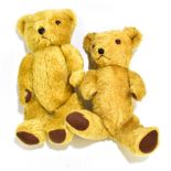 Two golden mohair teddy bears with amber glass eyes, stitched noses and mouths and cloth pads,