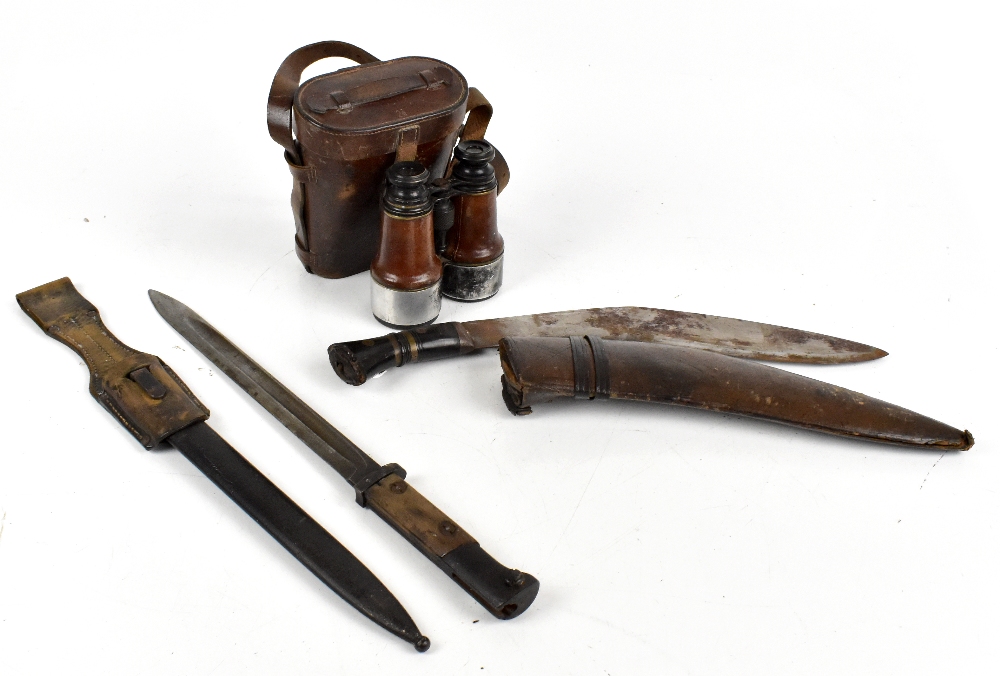 An early 20th century German K bayonet with wooden grip and fitted in metal scabbard, the blade