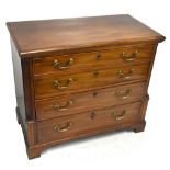 An early 19th century dressing chest of four drawers, the top drawer enclosing a fitted section with