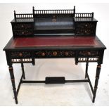 An Aesthetic Movement ebonised bonheur-du-jour with carved floral detail and pierced gallery back,