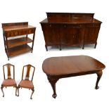 An early 20th century mahogany dining suite comprising wind-out extending dining table complete with