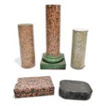 A collection of assorted granite including three columns and two plinths, height of largest column