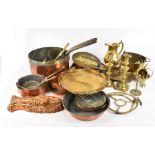 A quantity of copper and brass including pans, graduated small saucepans, chamber stick, etc.