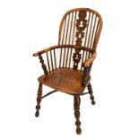 A 19th century yew wood Windsor elbow chair with elm seat above crinoline stretcher.Additional