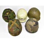 Five military and public service helmets comprising mid/late 20th century US helmet with webbing,