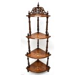 A Victorian inlaid walnut four tiered whatnot with wrythen turned uprights and platforms of bowfront