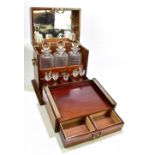 An Edwardian inlaid mahogany decanter box, the hinged cover enclosing mirrored panel and part fitted