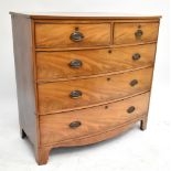 A 19th century mahogany bowfronted chest of two short over three long drawers, raised on bracket