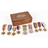 Nine WWII medals including the Defense medal, Burma Star, France and Germany Star, the Atalantic