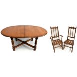 ERCOL; a medium elm table and chairs, comprising D-end extending dining table with extra leaf,