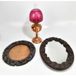 Two early 20th century oak carved wall mirrors, length of largest example 58cm, and a copper oil