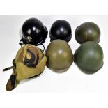 Six military and public service helmets comprising a khaki example with camouflage cover,