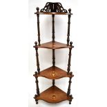 A Victorian inlaid walnut four tiered corner whatnot with wrythen twisted uprights and serpentine