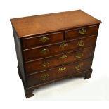 A Georgian oak straight front chest of two short over three long drawers, the drawers with