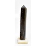 A tiger's eye mineral obelisk raised on alabaster plinth base, height 26cm.Additional