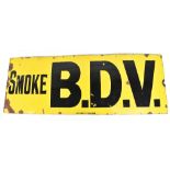 A large vintage enamelled sign 'Smoke B.D.V.' in black lettering on a yellow ground and inscribed '