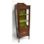 An Edwardian inlaid mahogany display cabinet, the single glazed door enclosing two fixed shelves