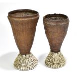 Two African woven trumpet form vases with cowrie shell encrusted decoration, height of largest