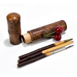 An unusual Black Forest pen holder, with applied cherry, length 17cm.Additional InformationMinor